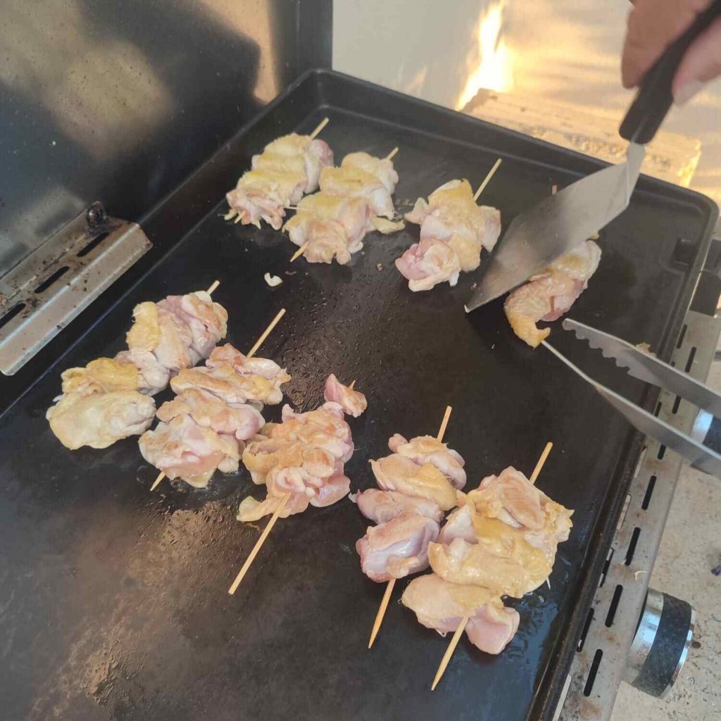 brochettes japonaises de poulet entrain de cuire à la plancha